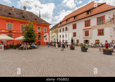 Sighisoara, Romania-July 03, 2015: Colourful crowds of tourists in the Old Town admire monuments Stock Photo