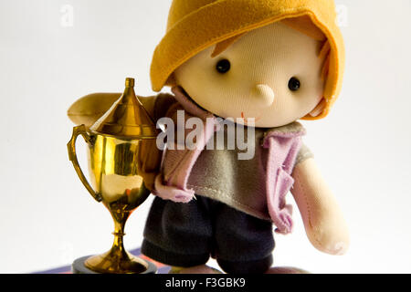 Soft toy boy with trophy on white background Stock Photo