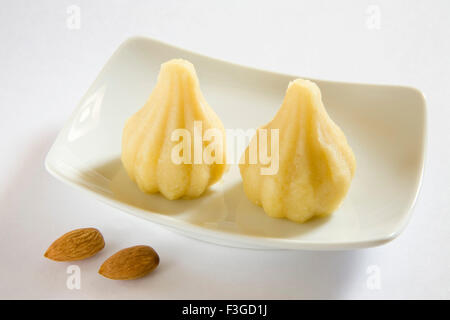 Indian food ; sweet badam ka modak dry fruits almond round shape ball cake bonbon Stock Photo