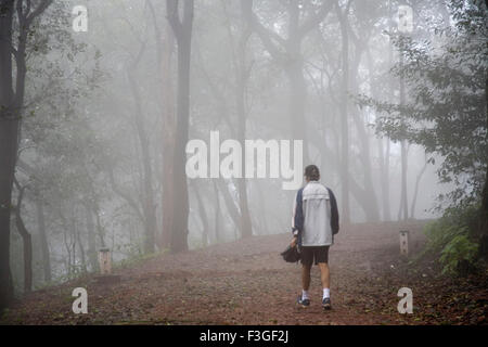 Man taking walk early morning on forest path ; Matheran ; Maharashtra ; India Stock Photo