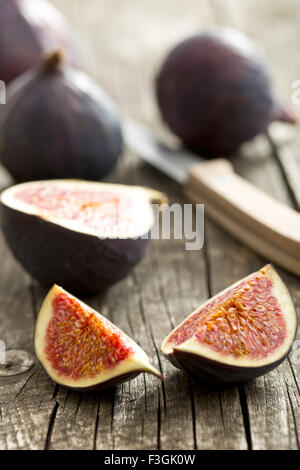 sliced fresh figs on old wooden table Stock Photo