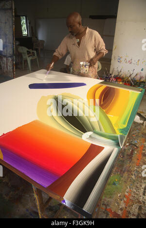 Indian contemporary artist Bose Krishnamachari in his studio working on canvas ; Bombay Mumbai ; Maharashtra Stock Photo