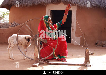 Lady working on spinning wheel ; Jodhpur ; Rajasthan ; India Stock Photo