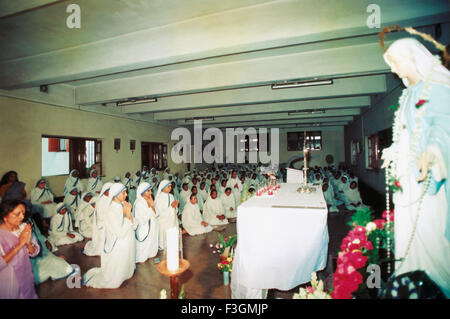 Sisters praying at Missionaries of Charity Mother House, Calcutta, Kolkata, West Bengal, India, Asia Stock Photo