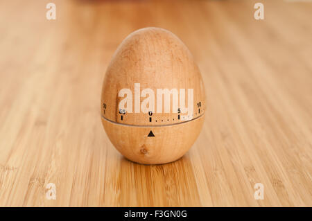 Egg timer on wooden surface set to zero Stock Photo