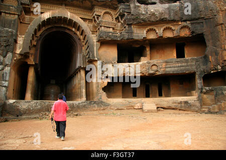 Tourist at Indian heritage place Bhaja caves entering Chitya hall built reign king Ashoka Lonavala Maharashtra Stock Photo