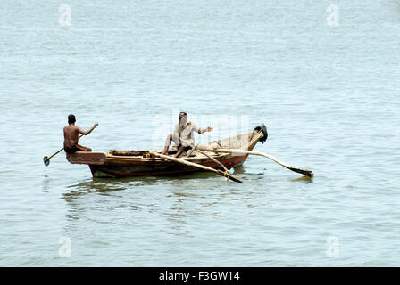 Boat man paddling his boat in Arabian sea ; district Sindhudurga ; Maharashtra ; India Stock Photo