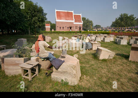 Two sculptors working near Tibetan temple ; Sarnath ; Varanasi ; Uttar Pradesh ; India Stock Photo