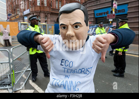 Manchester, UK. 7th October, 2015.An activist wears a George Osborne disguise for the Anti-Fracking protest outside the venue. A week of pro-peace, anti-austerity, anti-war, anti-Tory, protests dubbed 'Take Back Manchester' has been  organised by The People's Assembly and timed to coincide with the Conservative Party Conference in Manchester on 4th - 7th Oct 2015. Over 40 events are planned, including a speech by new Labour leader Jeremy Corbyn timed to compete with closing speech of Tory leader David Cameron Credit:  Graham M. Lawrence/Alamy Live News. Stock Photo