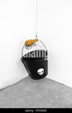 bucket with a grenade hanging in the air Stock Photo