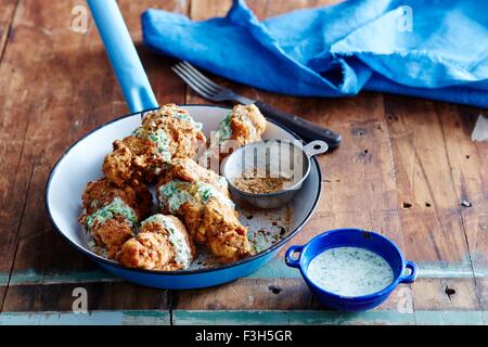 Cajun fried chicken with green chilli dressing Stock Photo