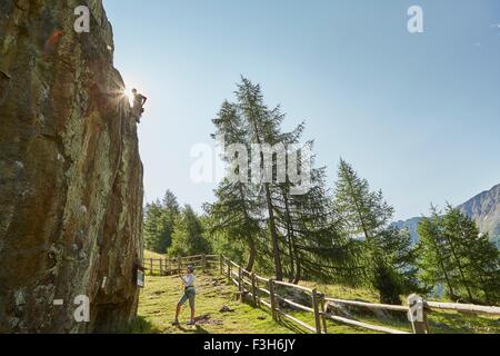 Young rock climbing couple climbing rock formation, Val Senales, South Tyrol, Italy