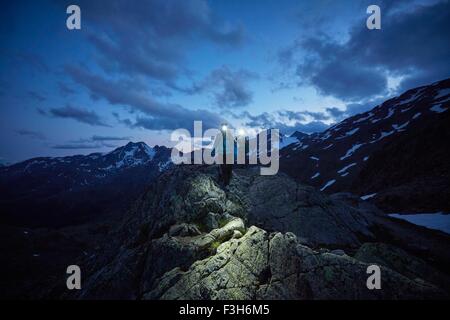 Young couple hiking at night wearing headlamps, Val Senales Glacier, Val Senales, South Tyrol, Italy Stock Photo