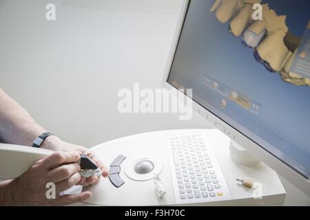 Dental technician at work, focus on hands Stock Photo