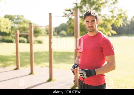 Portrait of mid adult man in park, preparing for workout Stock Photo