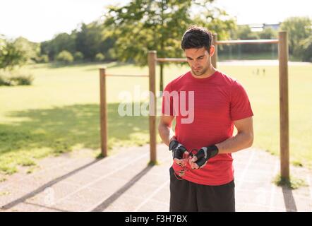 Mid adult man in park, preparing for workout Stock Photo