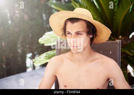 Portrait of young man wearing sunhat Stock Photo