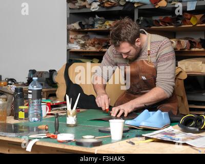 Shoemaker working in workshop Stock Photo