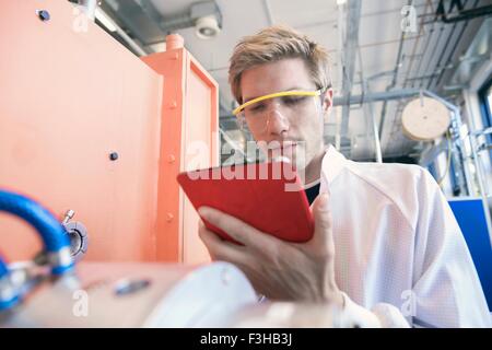 Factory technician using digital tablet Stock Photo