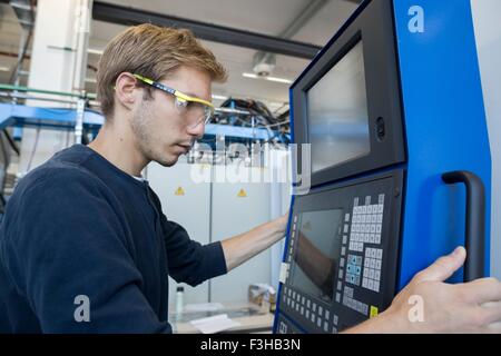 Factory technician working on control panel Stock Photo