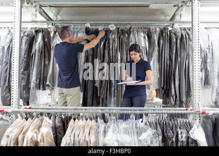 Two warehouse workers preparing garments in distribution warehouse Stock Photo