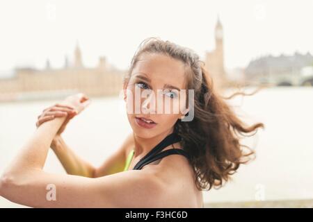 Female runner warming up on Southbank, London, UK Stock Photo