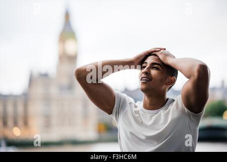Exhausted male runner taking a break on Southbank, London, UK Stock Photo