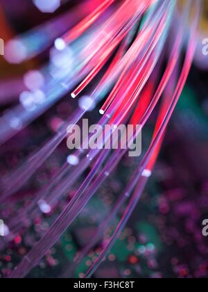 Fibre optics used to send data darting past computer circuit board Stock Photo