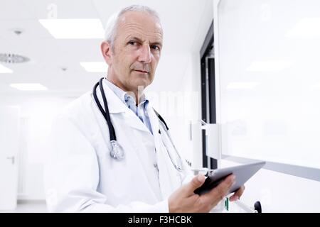 Portrait of male doctor holding digital tablet Stock Photo