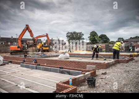 Workers laying bricks on construction site Stock Photo