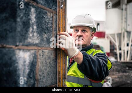 Workers laying bricks on construction site Stock Photo