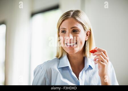 Young woman eating tomato sllice Stock Photo