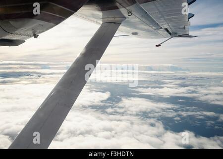 View of airplane wing above clouds Stock Photo