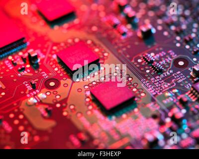 Close up detail of pink computer circuit board Stock Photo