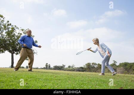 Senior couple playing badminton in park Stock Photo