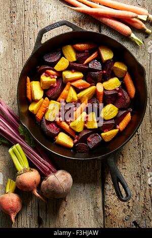 Still life of roasted golden and red beets with carrots in pan Still life of roasted golden and red beets with carrots in pan