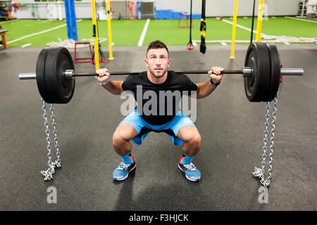 Young man, lifting weights Stock Photo