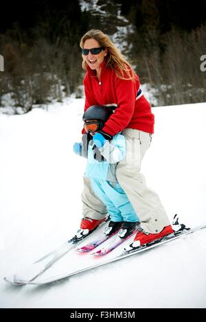 Male toddler in front of mother skiing downhill, Les Arcs,Villaroger,Savoie,France Stock Photo