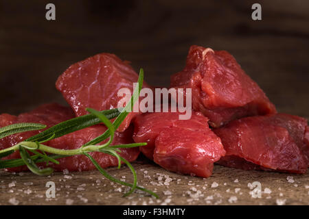 Raw beef with spices on wood background Stock Photo