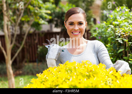portrait of beautiful young woman gardening at home Stock Photo