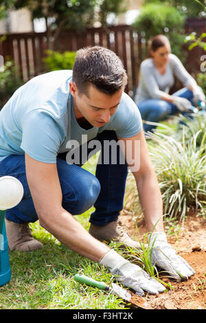 young couple working in home garden Stock Photo