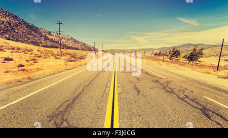 Retro old film style country highway in USA, travel adventure concept.