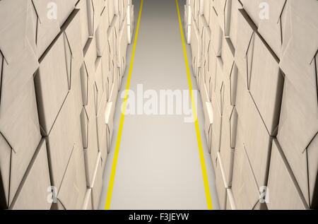 A direct top view of aisle of stacked wrapped boxes in a concrete warehouse Stock Photo