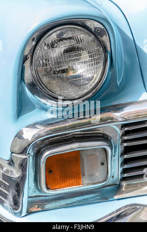 Meeting of classic american cars. Front headlights of, beautiful blue car, Chevrolet Bel Air, of 1956. Stock Photo