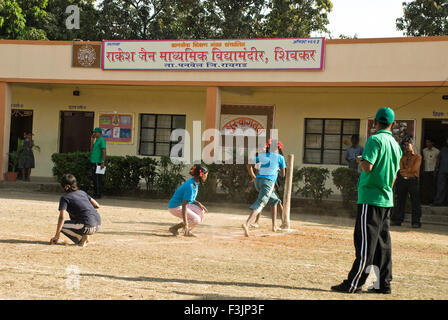 School children playing game of Kho Kho tag sport at Shivkar Village Panvel taluka Maharashtra India Stock Photo