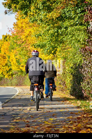 Old couple on bicycle in fall Stock Photo