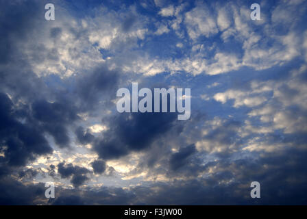 Dark Grey and white clouds with sparkling Sun at Pune ; Maharashtra ; India Stock Photo