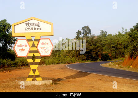 Mumbai 255 kilometer Decorated sign board sharp turn national highway number 17 Chiplun mid point of Mumbai Goa Ratnagiri maharashtra india Stock Photo