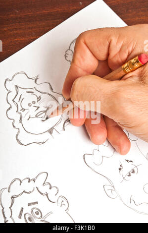 male hand drawing a cartoon figure Stock Photo