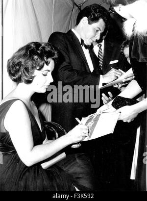 ELIZABETH TAYLOR  (1932-2011) Anglo-American film actress signs autographs with husband Eddie Fisher about 1960 Stock Photo